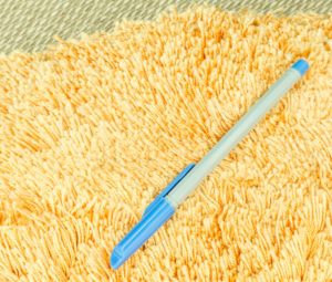 39097059 - blue pen on orange hair fur carpet on a mat