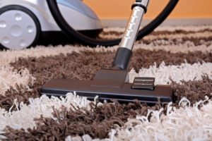 17183664 - vacuum cleaner on fluffy carpet