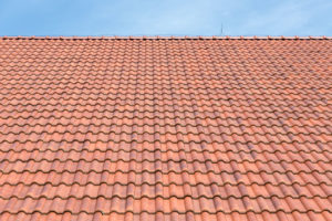 43526265 - red tiles roof background with blue sky